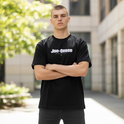 Joe the Goose Apparel black 100% cotton heavy tee with white logo and small orange goose graphic.