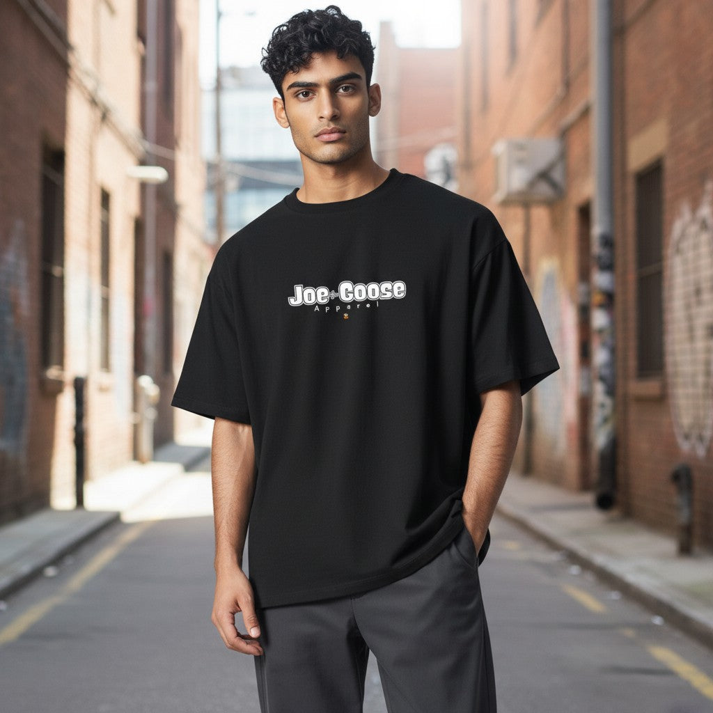 Joe the Goose Apparel black 100% cotton heavy tee with white logo and small orange goose graphic.