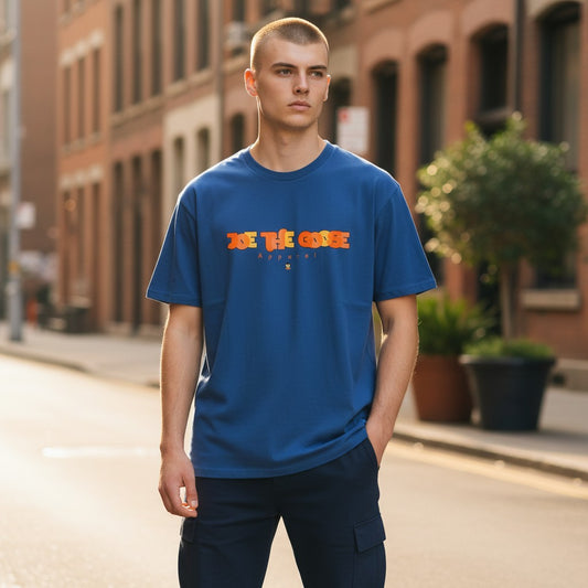 A model wearing a blue Joe the Goose Apparel heavy cotton t-shirt with a stained glass style graphic on the chest.