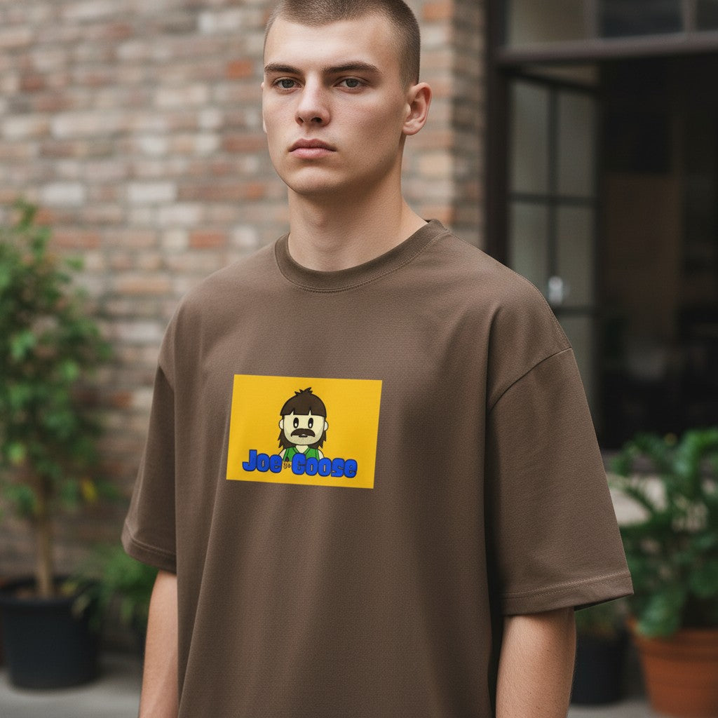 Model wearing a Joe the Goose Apparel brown heavy cotton tee with a yellow Joe the Goose graphic print.
