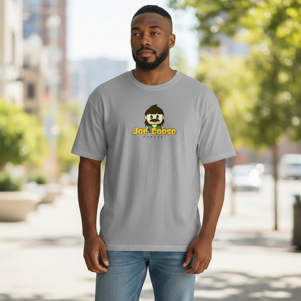 A man wearing a Joe the Goose Apparel grey heavy cotton t-shirt with a cartoon logo, styled with blue jeans.