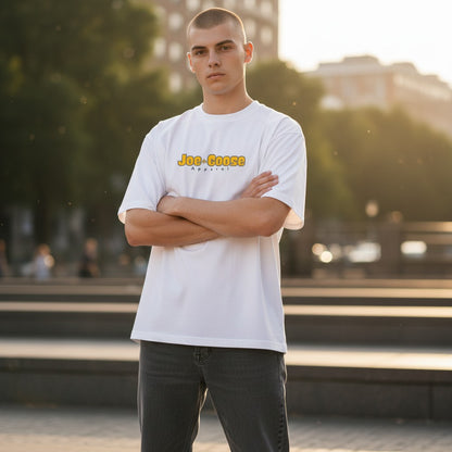Model wearing a white Joe the Goose Apparel heavy cotton tee with relaxed fit and logo in an outdoor urban setting.