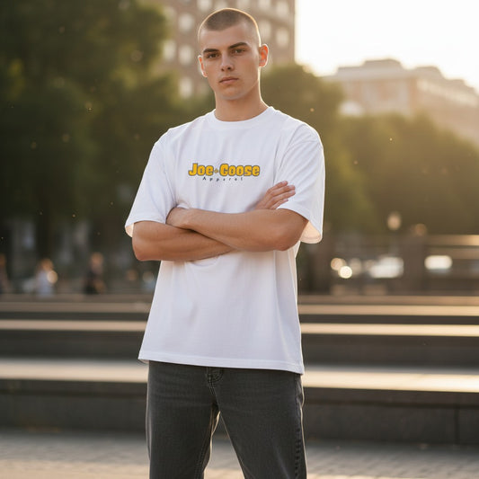 Model wearing a white Joe the Goose Apparel heavy cotton tee with relaxed fit and logo in an outdoor urban setting.