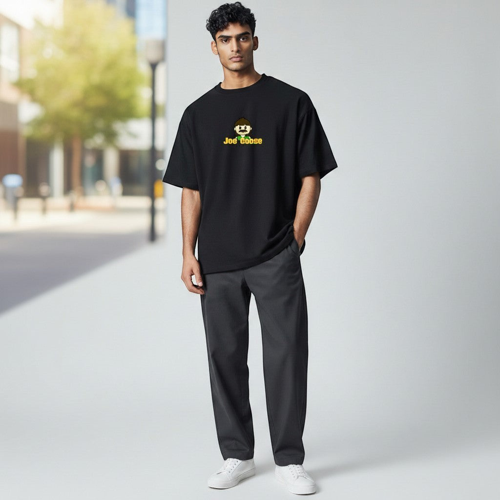 Model wearing a black Joe the Goose Apparel heavy cotton t-shirt with a relaxed fit and graphic logo on the chest.