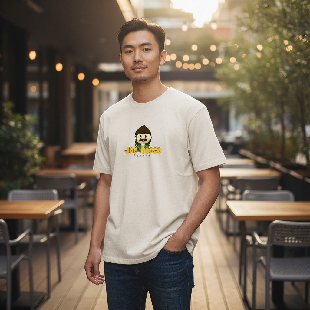 Man wearing a Joe the Goose Apparel heavy weight cotton t-shirt with a relaxed fit in an outdoor cafe setting.