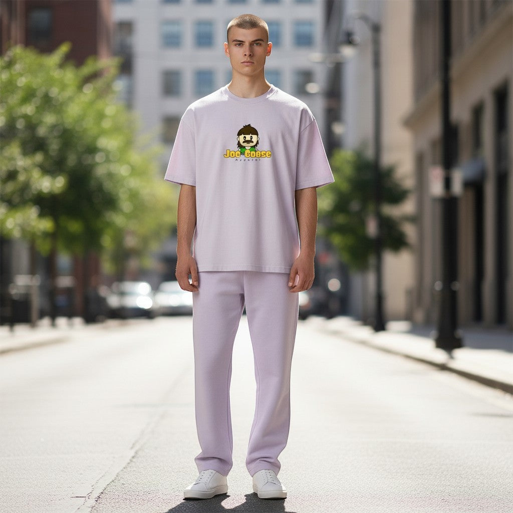 Model wearing a Joe the Goose Apparel lavender heavy cotton t-shirt with a relaxed fit and graphic logo on city street