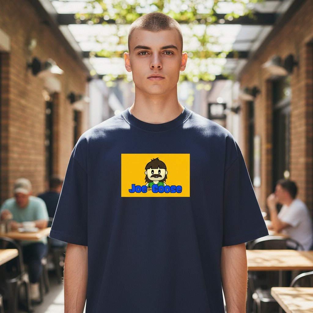 Model wearing a Joe the Goose Apparel navy heavy cotton t-shirt with a yellow graphic logo on the chest.