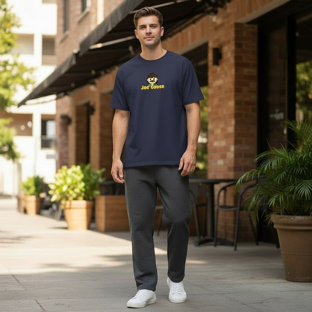 A man wearing a Joe the Goose Apparel navy blue heavy cotton t-shirt with a graphic print, styled for a casual look.